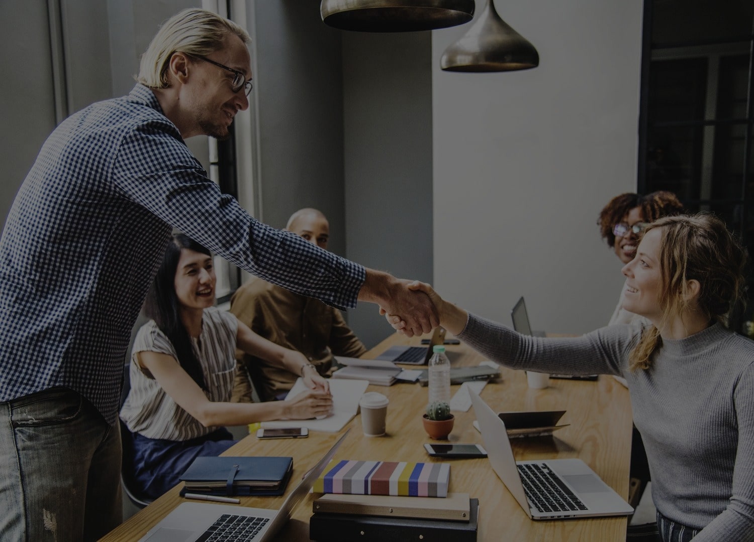 People shaking hands in a meeting